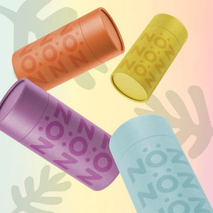 Four reef safe mineral stick sunscreens in "electric orange", "Lazer Yellow," "Static Blue" and "proton purple"