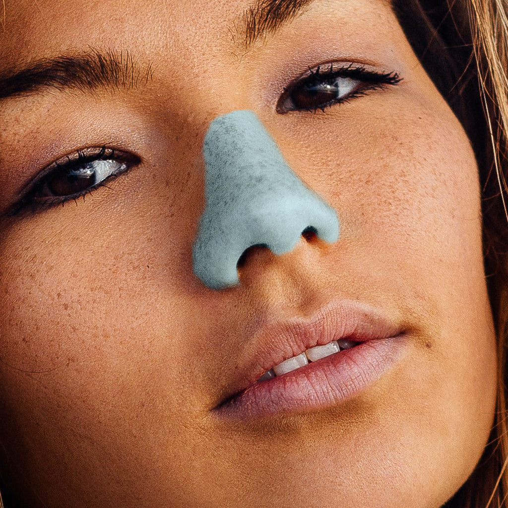 Woman with colored sunscreen on her nose